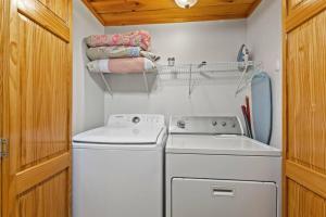 a small laundry room with a washer and dryer at Hot Tub & WiFi - Birdsong - Red River Gorge KY in Stanton +25 photos