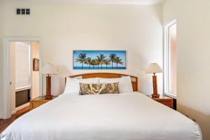 a bedroom with a large white bed with two lamps at Kapalua Bay Villas 32B4 · KBV 32B4 Oceanfront Kapalua Spectacula in Kahana +43 photos