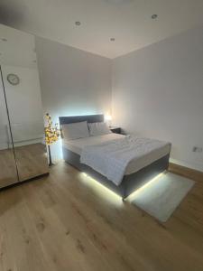 a bedroom with a bed with a light on it at Welcoming Home in London