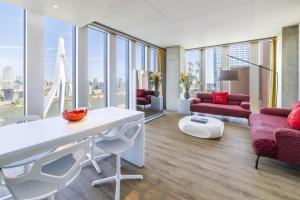 a living room with a white table and chairs at nhow Rotterdam in Rotterdam