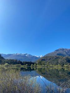 a view of a lake with mountains in the background at La cascada in Futaleufú