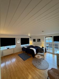 a bedroom with a bed and two large windows at Kilimanjaro & Stayover in Svinninge