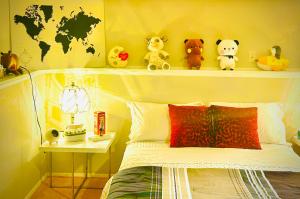 a bedroom with a shelf with stuffed animals on it at Stylish, artistic and cosy private guest house in Kelowna