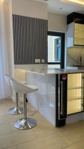 a kitchen with a counter and a bar with a stool at Eric Wilkins villas in Kampala