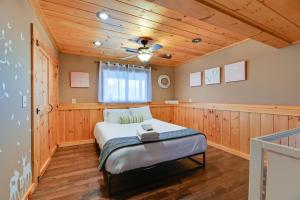a bedroom with a bed and a ceiling at Spacious Canandaigua Group Getaway House and Barn! in Honeoye