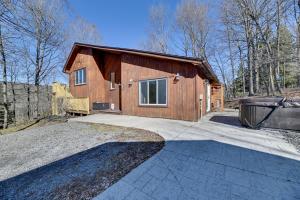 Una pequeña casa de madera con una gran entrada. en Spacious Canandaigua Group Getaway House and Barn!, en Honeoye
