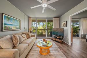 a living room with a couch and a flat screen tv at Maui Banyan H207 · MB H207 Maui Escape Near Beach, Pool & Hot Tu in Kihei