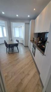 a kitchen and dining room with a table in the middle of it at Airport RMO in Chişinău