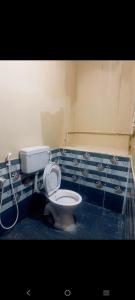 a bathroom with a toilet and a shower in it at SMK homestay in Rāmeswaram