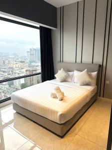 a bed in a room with a large window at AXON RESIDENCE BUKIT BINTANG KL CITY View in Kuala Lumpur