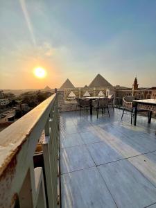 a balcony with tables and chairs and the pyramids at continental pyramids view in Cairo +44 photos