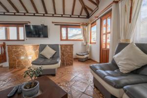 ein Wohnzimmer mit zwei Sofas und einem Fernseher in der Unterkunft BALCON DE CHIE in Villa de Leyva