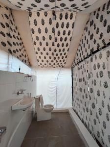 a bathroom with a toilet and a sink at Rann Rajvi Homestay in Dhordo