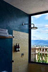 a bathroom with a blue wall and a window at El Diablo y La Luna B&B by El Diablo y La Sandia in Oaxaca City