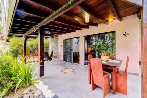 een buitenterras met een tafel en stoelen bij Villas Kiki in Puerto Viejo