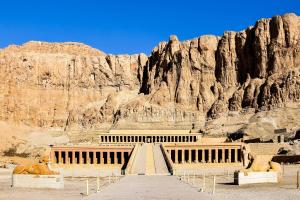 a staircase in front of a rocky mountain at Bab Al Firdaws House in Luxor