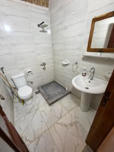 a bathroom with a toilet and a sink at Sahure Pyramid View Inn in Cairo +73 photos