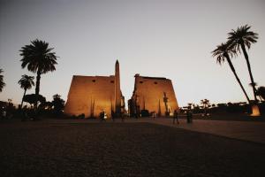 a group of people standing in front of two towers at Bab Al Firdaws House in Luxor