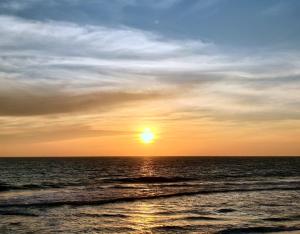 a sunset over the ocean with the sun in the sky at Gypsy Walker Plus in Varkala +9 photos