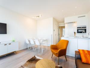 a kitchen and living room with a table and chairs at LaVue premier in Galopen +7 photos