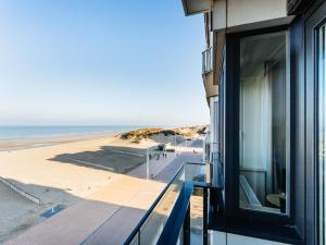 a building with a view of the beach from a balcony at LaVue premier in Galopen
