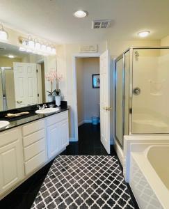 a bathroom with two sinks and a shower at Spacious Beachview End Unit in Legacy Tower 1 -1001 - 3 bedroom 3 bath condo in De Buys