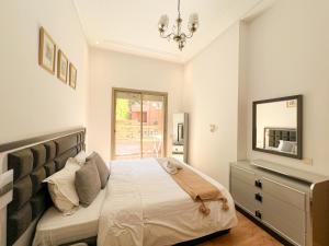 a bedroom with a bed with a mirror and a dresser at Condo in marrakech with pool in Marrakesh +52 photos