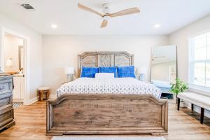 a bedroom with a large bed with blue pillows at BRAND NEW, fully furnished 3 bedroom, 3 bathroom home in Ocean Springs! in Gulf Hills