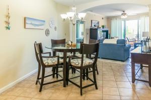 a dining room and living room with a table and chairs at Beachview Condo at Legacy Tower 2 -206 - fully furnished 2 bedroom 2 bathroom in De Buys