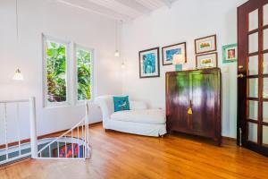a living room with a white couch and a window at Chalet Lulu with Solar Power and Hot Tub in Guaynabo in Puerto Nuevo