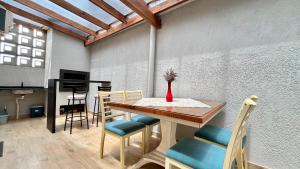 a dining room with a table and chairs at Casa pertinho do mar in Capão da Canoa