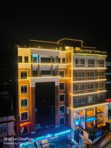 a tall building with lights in front of it at Prudential Hotel Nepal in Kathmandu