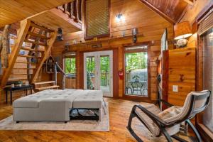 a bedroom with a bed and chairs in a cabin at Hot Tub & WiFi - Romantic Hideaway in Slade