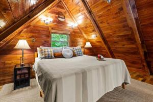 a bedroom with a bed in a wooden cabin at Hot Tub & WiFi - Romantic Hideaway in Slade