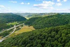 an aerial view of a road in the middle of a forest at Hot Tub & WiFi - Romantic Hideaway in Slade +41 photos