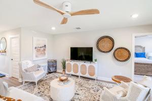 a living room with a ceiling fan and a tv at BRAND NEW, fully furnished 3 bedroom, 3 bathroom home in Ocean Springs! in Gulf Hills