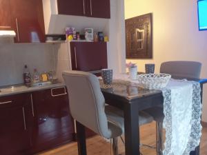 a kitchen with a table with chairs and a table cloth on it at Le briochin in Saint-Brieuc