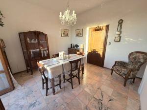 a dining room with a table and chairs and a chandelier at Dalla Tibi in Arezzo