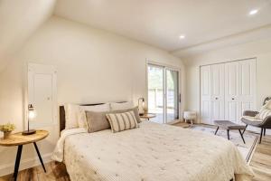 a bedroom with a large bed and a window at The Black Aframe - HOT TUB and Mountain Views in Evergreen Farms