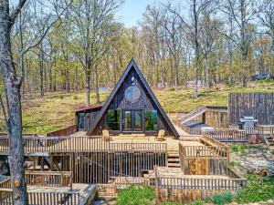 a home with a peaked roof and a deck with a house at The Black Aframe - HOT TUB and Mountain Views in Evergreen Farms