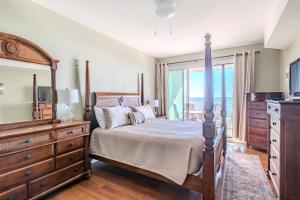 une chambre avec un grand lit, une commode et une télévision dans l'établissement Beachview Condo at Legacy Tower 1 -405 - fully furnished 3 bedroom 2 bathroom, à De Buys 26 autres photos