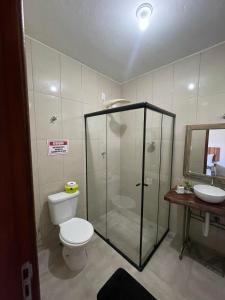 a bathroom with a shower and a toilet and a sink at Chalés Quintal da Serra in Lavrinhas +15 photos