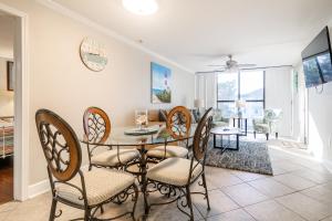 a dining room with a table and chairs at Cozy 2 bed 2 bath condo at the beachside Ocean Club Villas in Beauvoir
