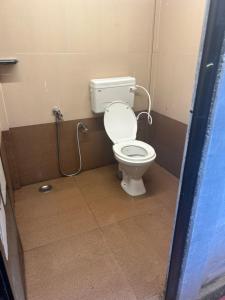 a bathroom with a toilet in a stall at Mystic Valley Vattavada in Kottakamboor