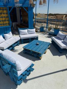 a group of couches and a table with pillows at Dar Zénith - Free Breakfast - Résidence Oasis Tozeur in Tozeur