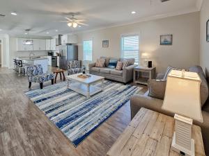 a living room with a couch and a table at Brand New Home with Beach Views! Fully furnished 3 bedroom home in Gulfport in Gulfport