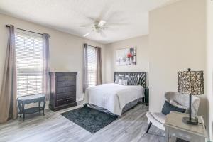 a bedroom with a bed and a dresser and a chair at Legacy Villa 506 - 2 bedroom 2 bath with garage in beachside neighborhood in De Buys +20 photos