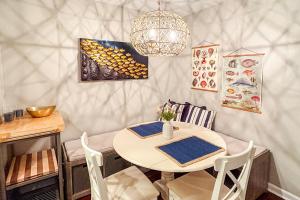 a dining room with a white table and chairs at Waterfront condo at Harbor Landing G02 - Relax in BEAUTIFUL Ocean Springs in Gulf Park Estates