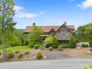 a large house with a gambrel roof at Overlook at Wilderness Trail in Newland