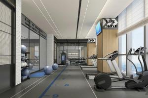 a gym with treadmills and exercise equipment in a building at Four Points by Sheraton Kunming Guandu in Kunming